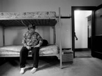 Army veteran and resident, Bill O'Connor, sits on an empty bed waiting for his turn in the shared bathroom at the Veterans Transition House currently housed at the rectory of the now closed St. John church on County Street in New Bedford, MA. A new building is scheduled tol be constructed in 2019.   PHOTO PETER PEREIRA